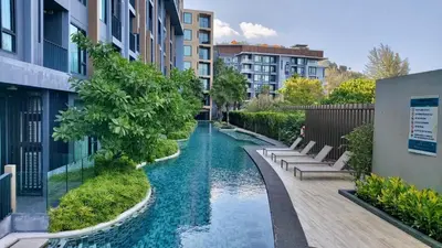 a swimming pool in the middle of a city with buildings at Aristo Resort Surin Beach J16 in Phuket Town