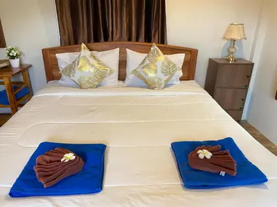 a bedroom with a bed with two towels on it at Relaxing House Koh Yao Yai in Ko Yao Yai