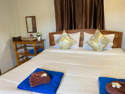 a bedroom with a bed with two towels on it at Relaxing House Koh Yao Yai in Ko Yao Yai