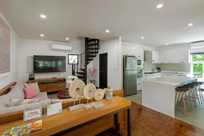 a kitchen and living room with a couch and a table at Patong Garden House - Luxury Villa in Patong Hills in Patong Beach