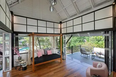a living room with a couch on a balcony at Patong Garden House - Luxury Villa in Patong Hills in Patong Beach