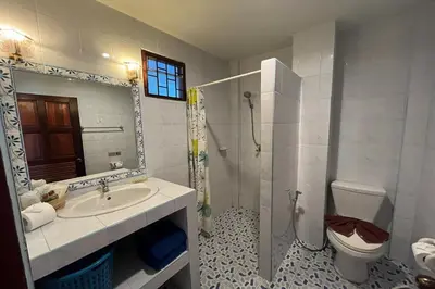 a bathroom with a sink and a toilet and a shower at Ginis Beach Resort in Kamala Beach