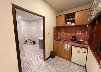 a kitchen with a sink and a toilet in a bathroom at Ginis Beach Resort in Kamala Beach