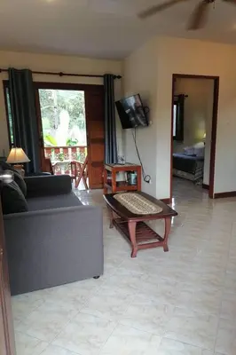 a living room with a couch and a coffee table at Ginis Beach Resort in Kamala Beach