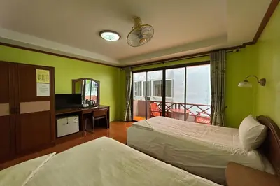 a hotel room with two beds and a balcony at Me Mee Place & Tour Krabi in Ao Nang Beach