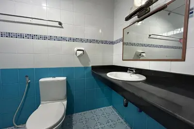 a bathroom with a toilet and a sink at Me Mee Place & Tour Krabi in Ao Nang Beach