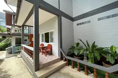a home with a porch with plants on it at Me Mee Place & Tour Krabi in Ao Nang Beach