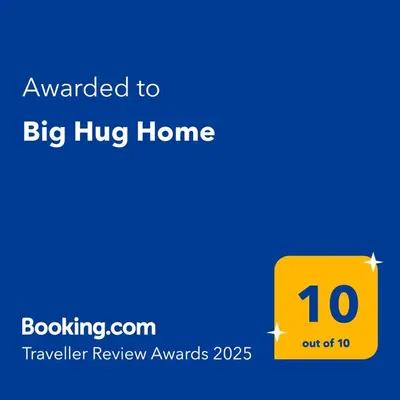 a yellow sign that reads awarded to big hug home at Big Hug Home in Ko Yao Noi