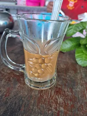 a glass mug filled with coffee on a table at Big Hug Home in Ko Yao Noi