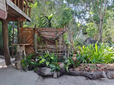 an outdoor garden with plants and a wooden structure at Big Hug Home in Ko Yao Noi
