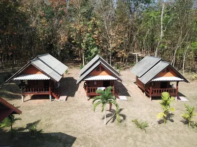 an overhead view of three huts in the sand at Mr Bao Homestay & Bungalows in Ko Yao Noi