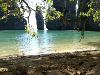 a view of a beach with rocks in the water at Mr Bao Homestay & Bungalows in Ko Yao Noi