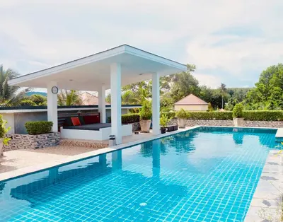 a swimming pool with a gazebo next to a house at Destination39 in Thalang