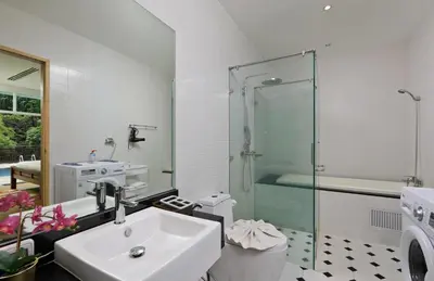 a bathroom with a sink and a glass shower at Suite Cascade 2BR Family Deluxe Kamala Falls in Kamala Beach