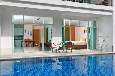 a room with a pool and a bedroom with a bed at Suite Cascade 2BR Family Deluxe Kamala Falls in Kamala Beach