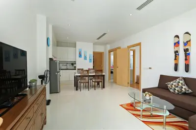 a living room and kitchen with a couch and a table at Suite Cascade 2BR Family Deluxe Kamala Falls in Kamala Beach
