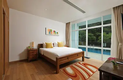 a bedroom with a bed and a large window at Suite Cascade 2BR Family Deluxe Kamala Falls in Kamala Beach