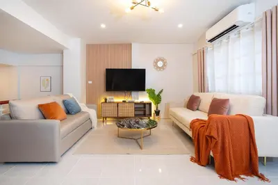 a living room with a couch and a tv at Bangla house with 4 houses Pick house before BOOK in Patong Beach