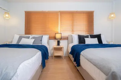 a bedroom with two beds and a window at Bangla house with 4 houses Pick house before BOOK in Patong Beach