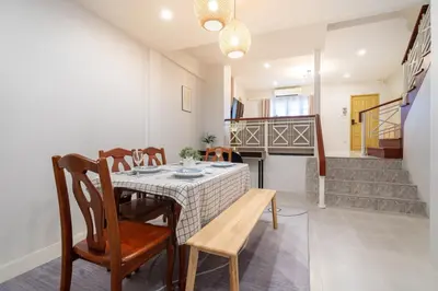 a dining room with a table and chairs and stairs at Bangla house with 4 houses Pick house before BOOK in Patong Beach