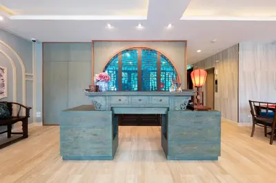 a blue desk in a room with a stained glass window at Sino Siam Hotel in Klong Muang Beach