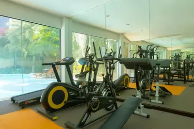 a gym with a bunch of exercise bikes in it at NaiHarn Sea Condo by Holy Cow, 1-BR, mountain view in Nai Harn Beach