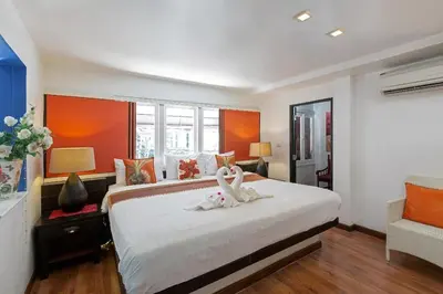 a bedroom with two swans sitting on a bed at Baipho Lifestyle in Patong Beach