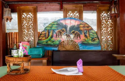 a dining room with a table with a napkin at The Expat Hotel Patong in Patong Beach