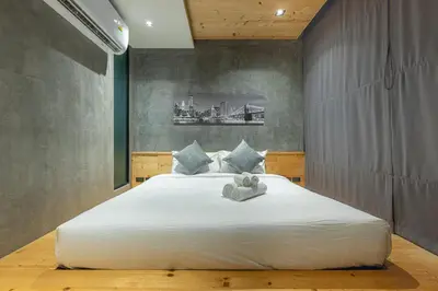 a bedroom with a large white bed in a room at Relife Windy by Holy Cow, courtyard view in Nai Harn Beach