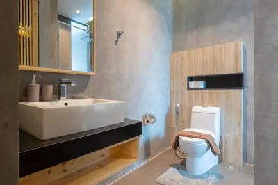 a bathroom with a white sink and a toilet at Relife Windy by Holy Cow, courtyard view in Nai Harn Beach