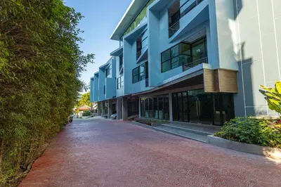 an empty street in front of a building at Relife Windy by Holy Cow, courtyard view in Nai Harn Beach