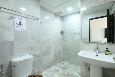 a white bathroom with a sink and a toilet at NaiHarn Sea Condo, Top floor, Mountain View in Nai Harn Beach