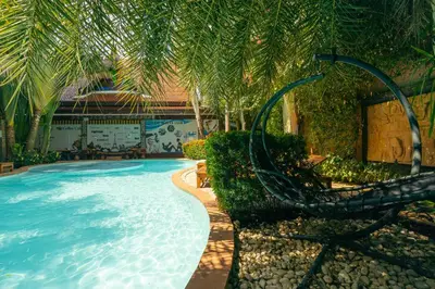 a swimming pool with a slide in a resort at NaiHarn Sea Condo, Top floor, Mountain View in Nai Harn Beach