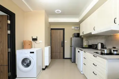 a kitchen with a washing machine and a washer at NaiHarn Sea Condo, Top floor, Mountain View in Nai Harn Beach