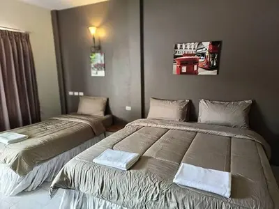 a bedroom with two beds with towels on them at Andaman Place in Thalang