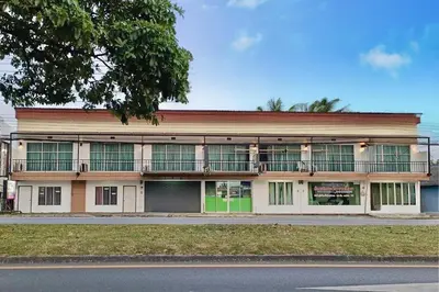an apartment building with a balcony on the side of a street at Andaman Place in Thalang
