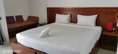 a bedroom with a bed with a stuffed animal on it at Sure Guesthouse in Kamala Beach
