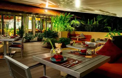 a restaurant with tables and chairs and plants at Kata gardens 2 bedroom near Kata beach 3B in Kata Beach