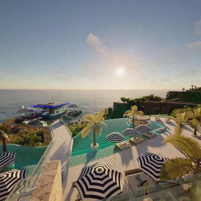 a view of a pool with umbrellas and the ocean at Kata gardens 2 bedroom near Kata beach 3B in Kata Beach