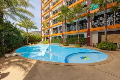 a large swimming pool in front of a building at NBC Condo, 2-BR, NaiHarn Beach in Nai Harn Beach