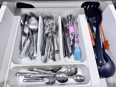 a drawer filled with silver utensils and spoons at NBC Condo, 2-BR, NaiHarn Beach in Nai Harn Beach