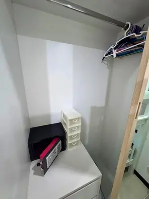 a small white room with a shelf and a microwave at NBC Condo, 2-BR, NaiHarn Beach in Nai Harn Beach