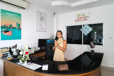a woman standing in front of a desk at Grand View in Patong Beach