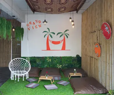 a room with two beds and a swing at Grand View in Patong Beach