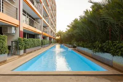 a swimming pool in the middle of a building at NaiHarn Pearl condo by Holy Cow, 1-BR, courtyard view in Nai Harn Beach