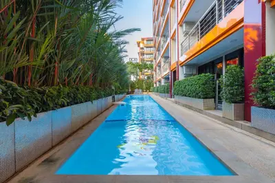 a swimming pool in the middle of a building at NaiHarn Pearl condo by Holy Cow, 1-BR, courtyard view in Nai Harn Beach