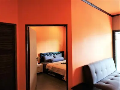 a bedroom with a mirror and a bed in it at Phurafa Resort in Phang-nga