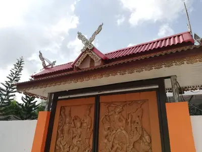 a door to a temple with a carving on it at Phurafa Resort in Phang-nga