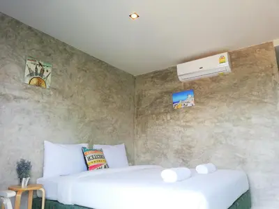 a bedroom with two white beds in a room at Laemsai Resort in Thalang