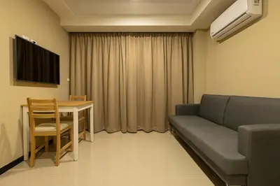 a living room with a couch and a table at NaiHarn Sea Condo by Holy Cow, 1-BR, courtyard view in Nai Harn Beach
